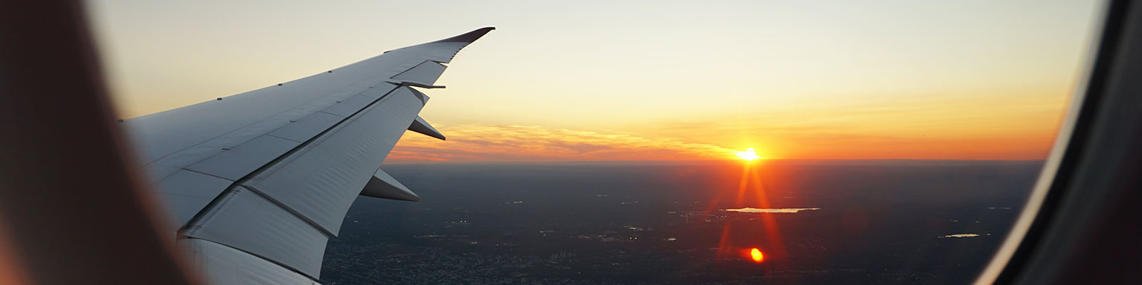 view of a sunset out the window of an airplane